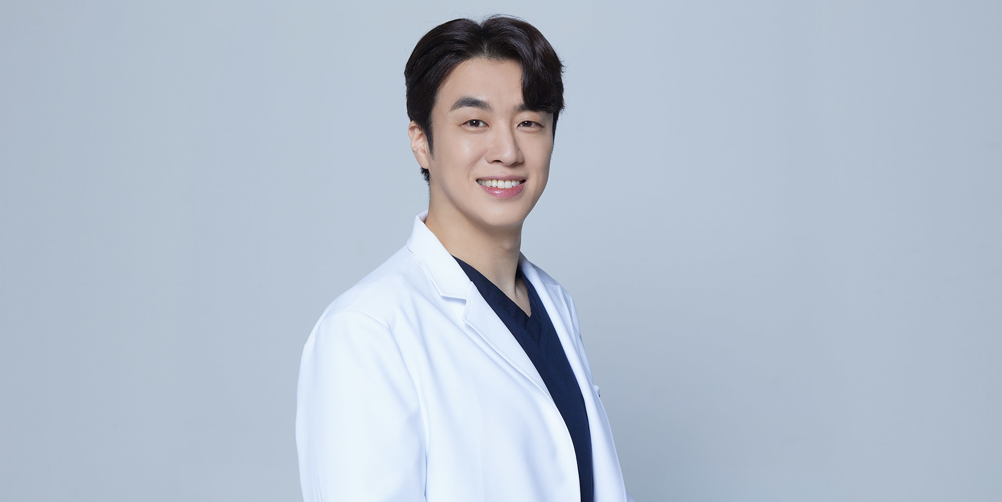 Dr. JuYoung JEONG, certified by the Ministry of Health and Welfare, wearing a white lab coat and smiling confidently against a plain background. • KOREA NEW N DENTAL CLINIC